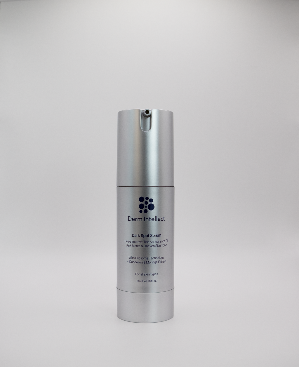 Derm intellect Dark Spot Serum in a sleek silver cylindrical pump bottle, centered against a neutral light gray background.